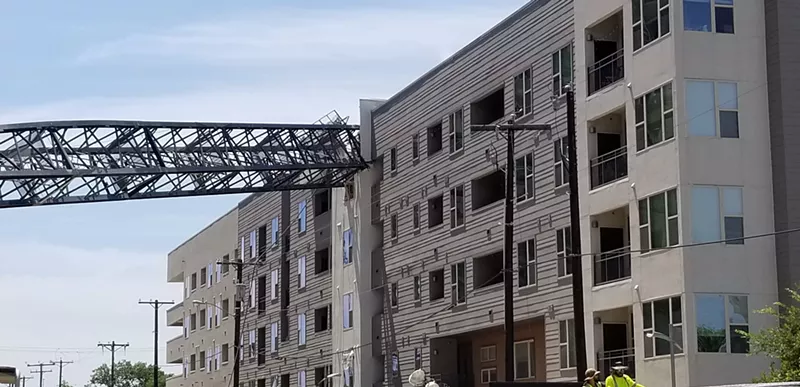 Image: A crane crashed into the Elan City Lights apartment complex Sunday afternoon. The apartment's management company determined the building is "totally unusable for residential purposes."