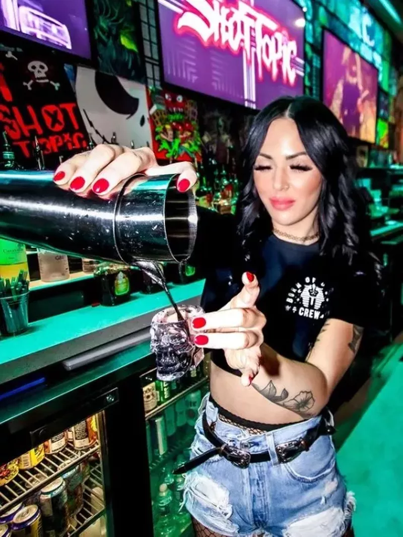 Image: A bartender pours a shot of "The Taste of Ink" at Shop Topic on Crowdus Drive in Deep Ellum.