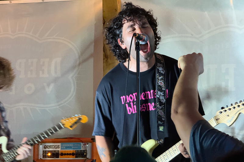 Image: Man screaming into a microphone on stage