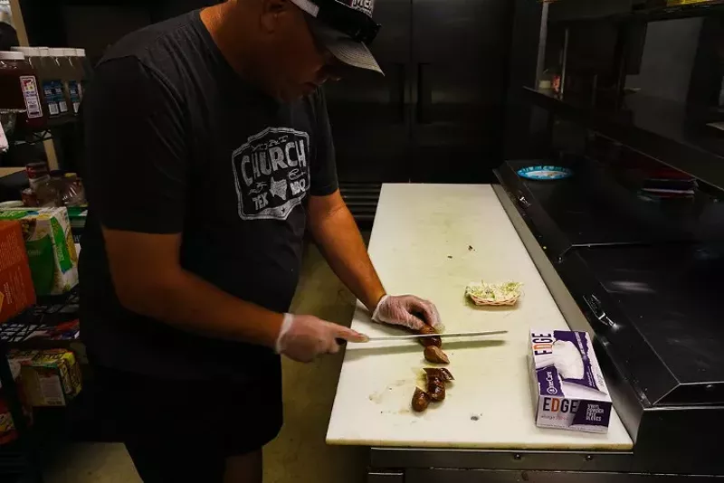 Image: Bet the House co-owner Shawn Eagle slices house-made sausage.
