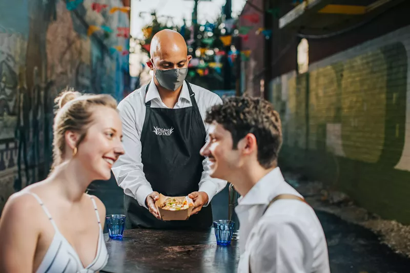 Image: Cameron Cook and Amanda Jewell dine at Las Almas Rotas, where Ivan Pereira serves them their food.
