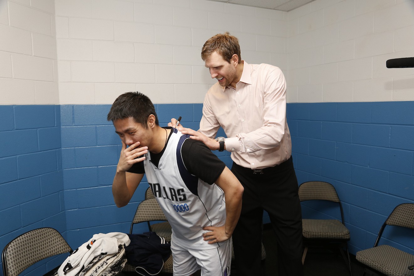 Shen Xu gets emotional as Dirk Nowitzki signs his shirt during a visit to Dallas.
