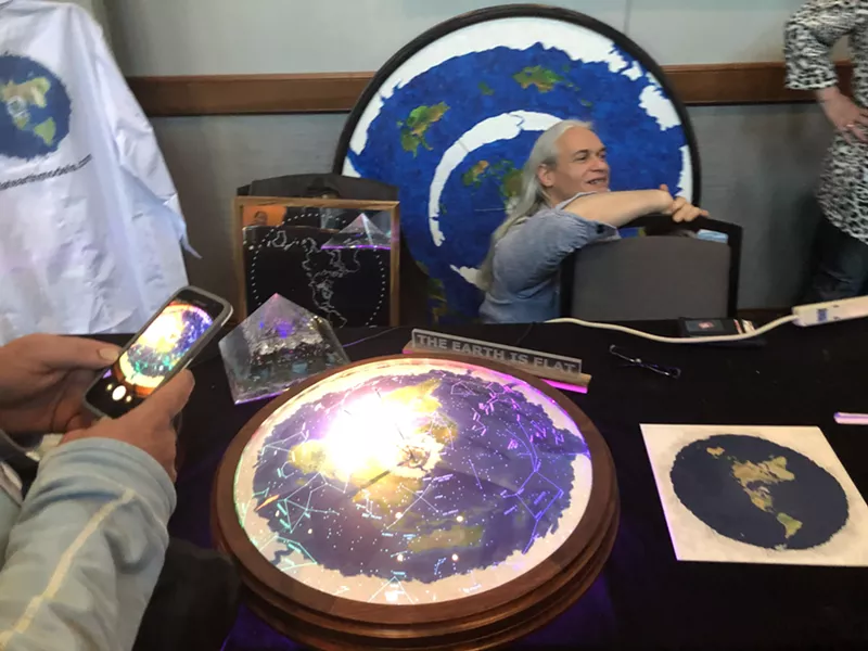 Image: Flat Earth model builder Chris Pontius converses with guests at the Flat Earth International Conference held in November at the Frisco Hotel and Convention Center.