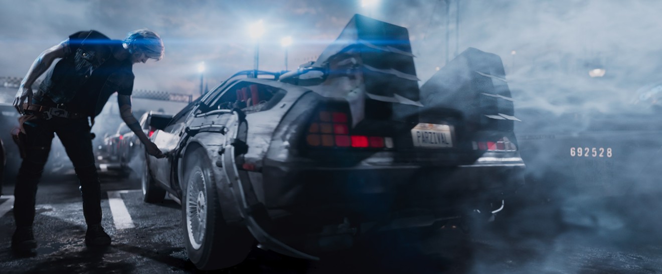 Parzival, played by Tye Sheridan, steps into a 1982 DeLorean DMC-12 that looks like Doc Brown's time machine from the '80s sci-fi comedy Back to the Future.