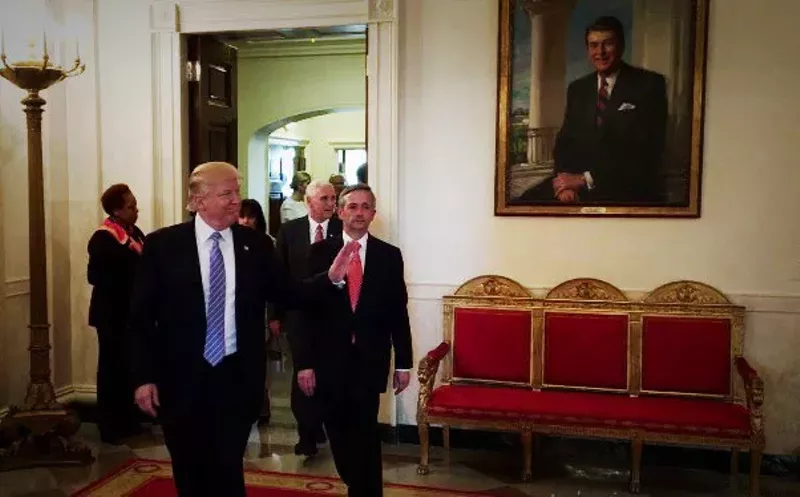 Image: Donald Trump and Robert Jeffress walk past a Ronald Reagan at the White House this week.