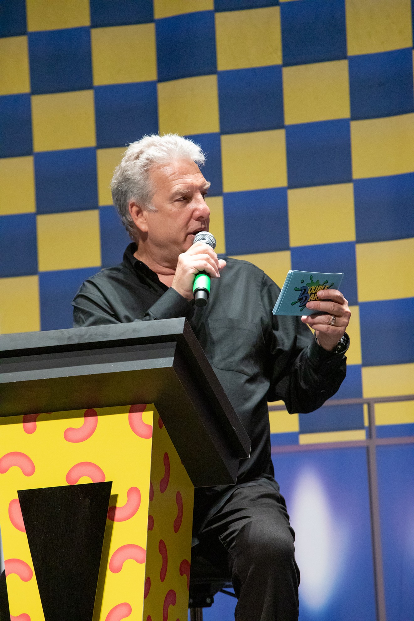 Double Dare host Marc Summers challenges a team of kids to answer a trivia question or take the physical challenge during a live stage show of the super sloppy Nickelodeon game show.