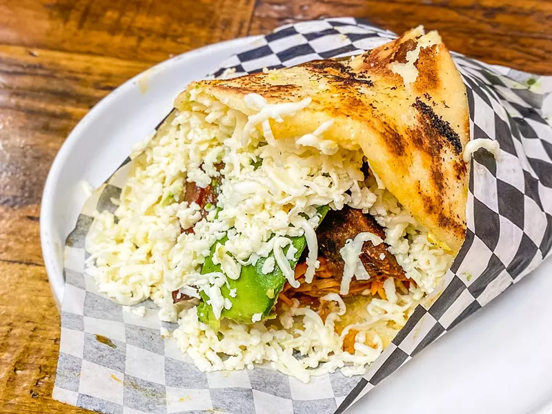 Image: Arepas Venesuela: shredded chicken, shredded meat, pork, avocado and cheese in a white corn cake