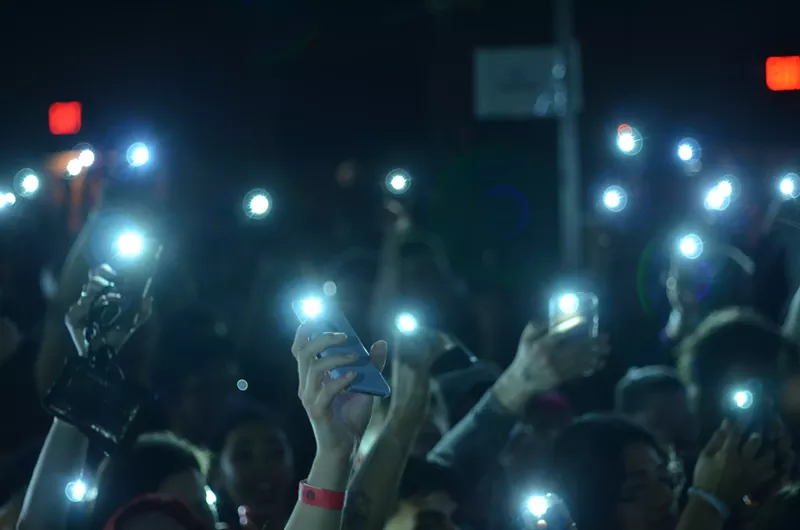 Image: Emo Nite attendees sway their phone lights back-and-forth to “Welcome to the Black Parade” by My Chemical Romance.