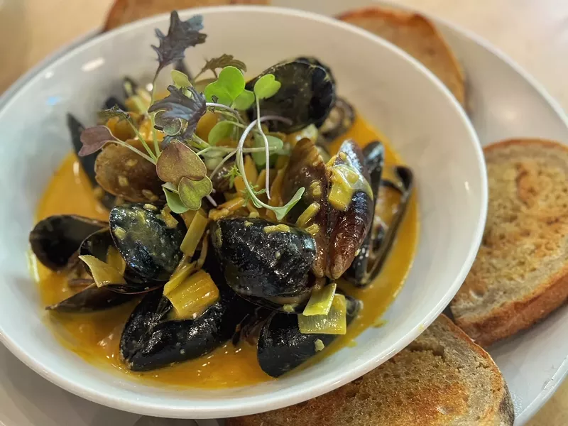 Image: Mussels with melted leeks in a rich butter broth with turmeric at Sachet is typical of the dishes often served at a Feast of Seven Fishes Christmas Eve meal.