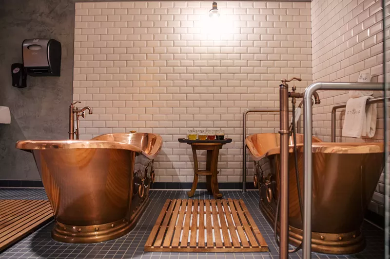 Image: A pair of beer spa tubs with a beer flight inside Pivovar in Waco.