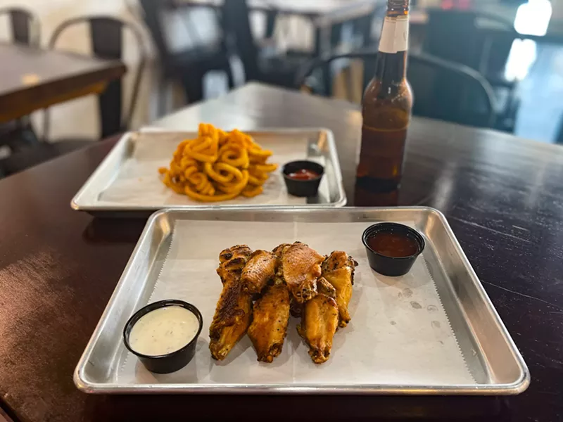 Image: Smoked wings, cold beer and curly fries at Bad Chicken.