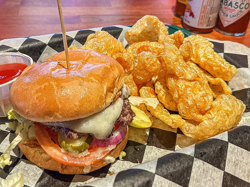 Image: A quarter-pound brisket and short rib burger with some really good chicharrónes.
