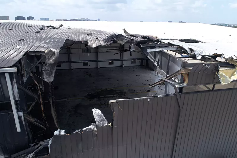 Image: Damage to a hangar at Addison Airport is captured in this photo taken by an NTSB drone Monday. The hangar was damaged when a Beechcraft Super King Air 350i crashed into the hangar during takeoff Sunday.