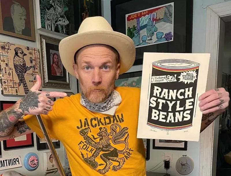 Image: Fort Worth artist Jack Daw poses with a drawing of Ranch Style beans. He draws Texas scenes like no other: with humor and wit.