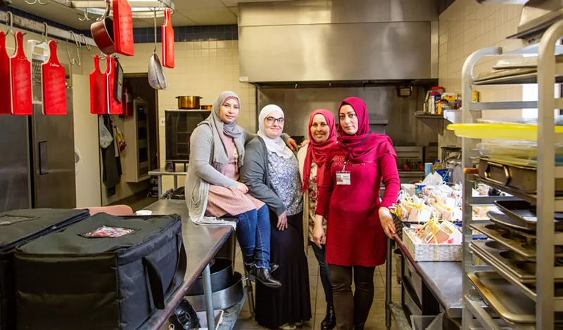 Image: Rania Alahmad, Rasha Sultan, Nawarah Shaker and Maissa Alkhadir after cooking for an event catered by Break Bread, Break Borders.
