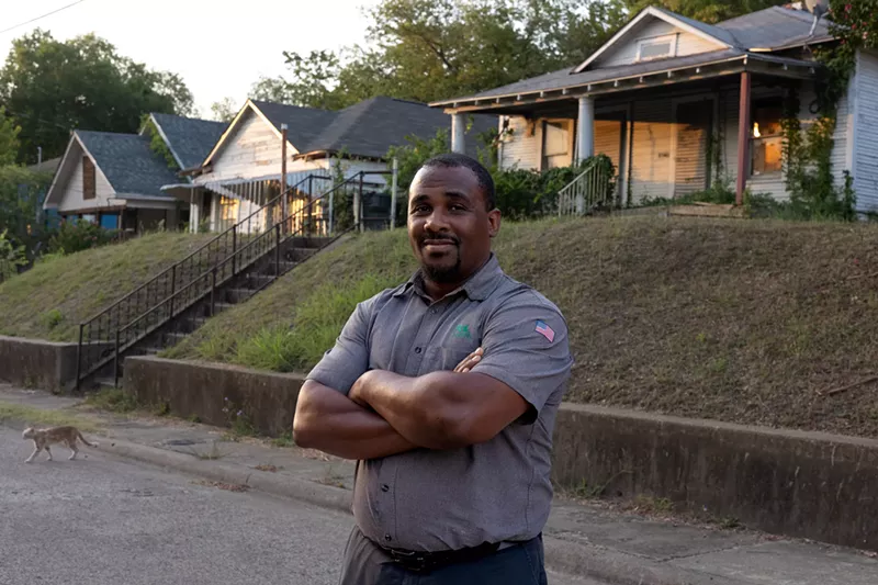 Image: Larry Johnson in front of a home he is restoring in the Tenth Street neighborhood.