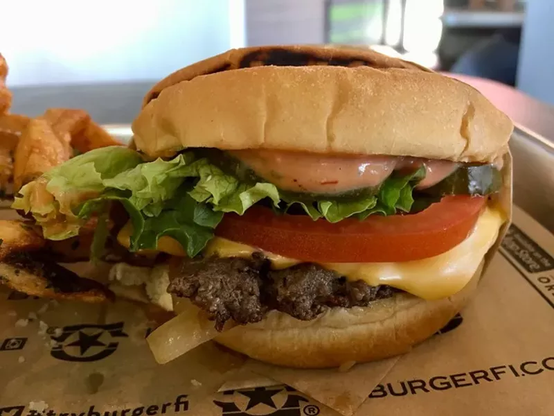 Image: A just-under-$6 cheesebuger at the new BurgerFi on Mockingbird with American cheese, grilled onions, lettuce, tomato and BurgerFi sauce.