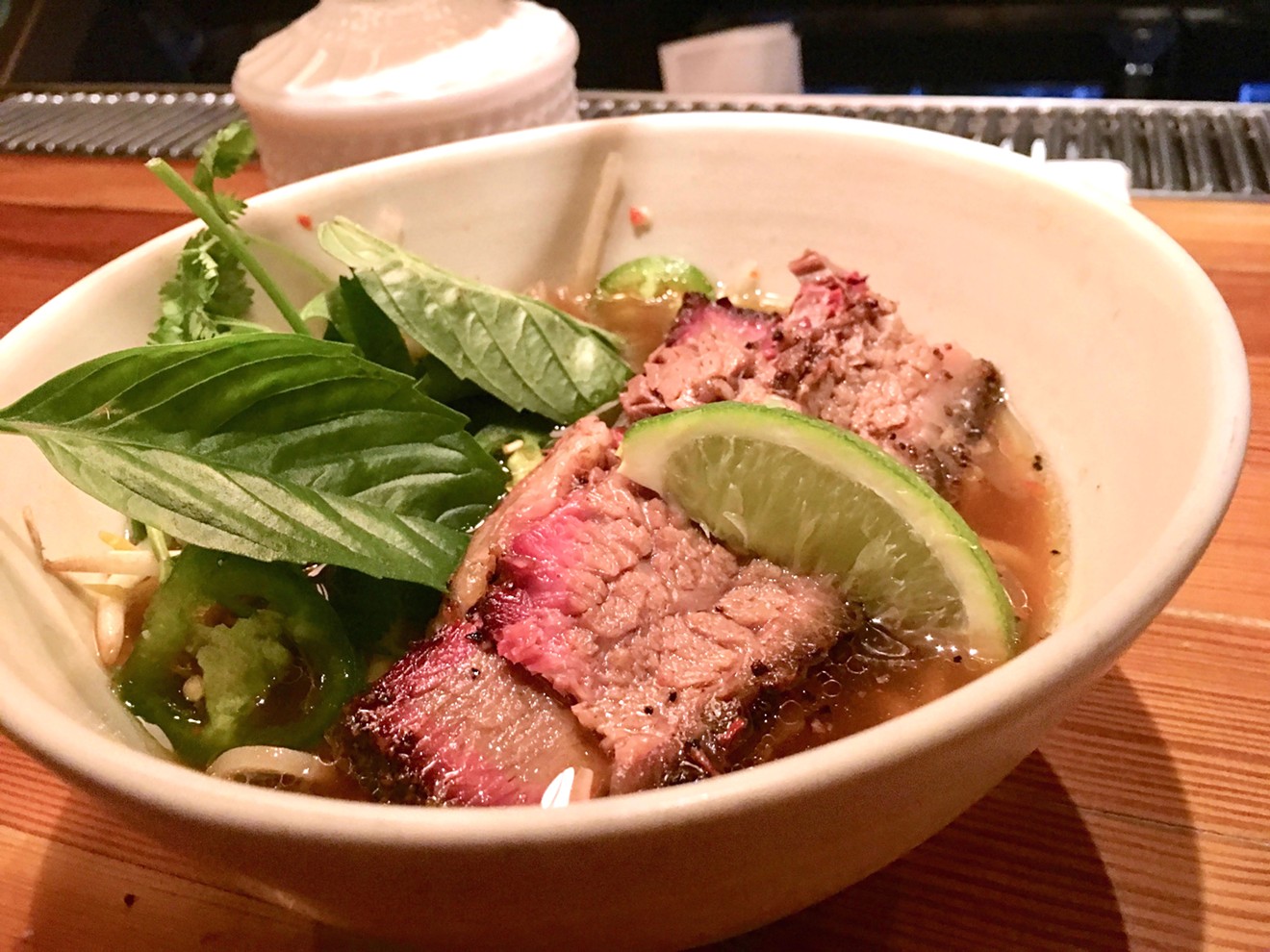 A bowl of Aaron Franklin's brisket in a flurry of broth and herbs set diners back $17 and an hour wait, but Dallas diners seemed more than happy to try the Austin pitmaster's goods at Top Knot's Uncommon Ramen series.