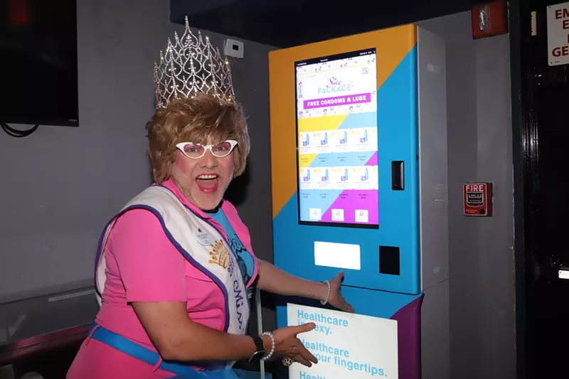 Image: Miss LifeWalk 2023, Aunt Marge, poses with the Nice Package vending machine at Woody's.