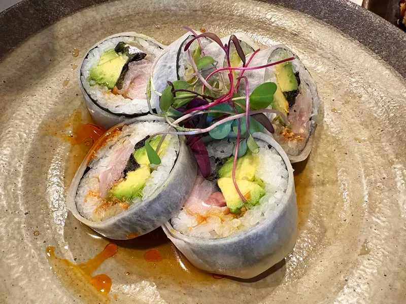 Image: The Negi Hama roll features fresh yellowtail (hamachi), green onion, avocado, candied garlic, yuzu kosho, spicy ponzu and chili oil.