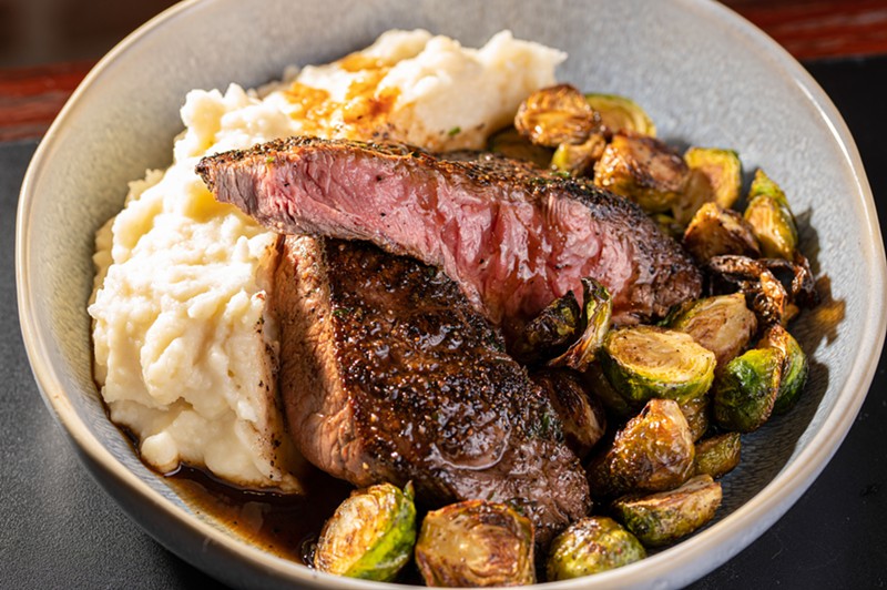 Pepper crusted flat iron steak with compound butter, whipped potatoes, brussel sprouts