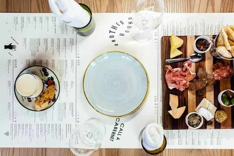 Image: Moscato creme and berries (left) and a meat and cheese board, photographed at the Sixty Vines in Plano.