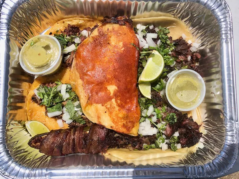 Image: The cheesy taco stuffed with brisket (center), two street tacos (right), two quesitacos (left) and the Texas Twinkie (bottom left) from 225 BBQ.