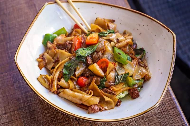 Image: The pad kee mow with tenderloin and Thai basil in a light sauce, along with tomatoes, onions and sliced bell peppers for $14