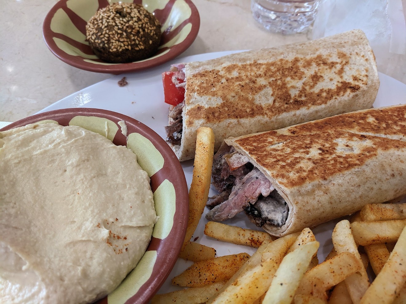 A beef shawarma sandwich with hummus, fries and stuffed falafel at One Hummus in Richardson.