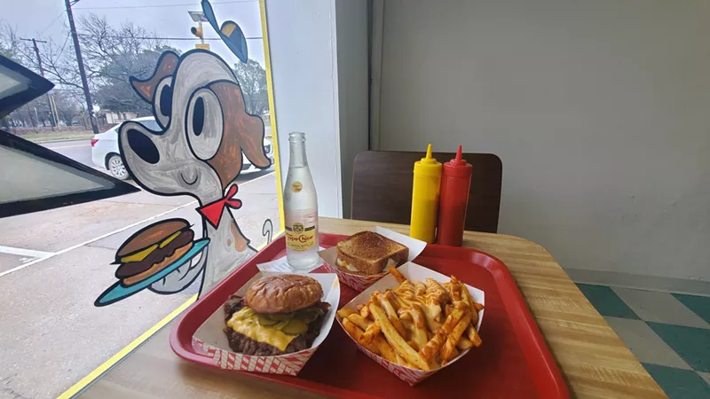 Image: a burger and fries at a window seat at herby's burgers.