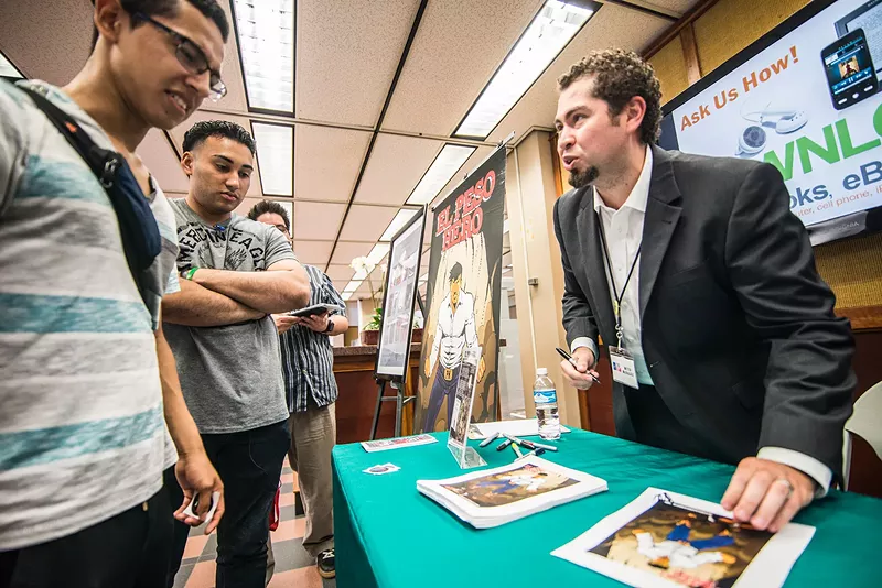 Image: Comic book artist Hector Rodriguez talks with UT Dallas students at welcome week book signing.