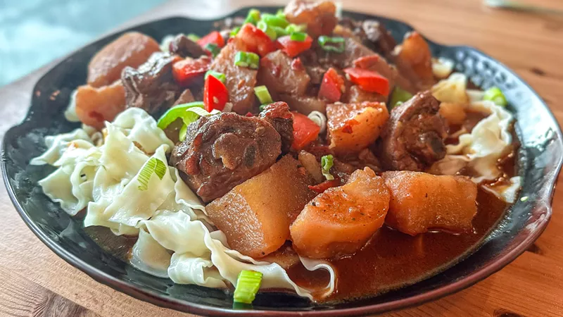 Image: A wonderfully flavored stew of braised chicken, potatoes and spices, is alone worth the price of admission to Turan Uyghur Kitchen.