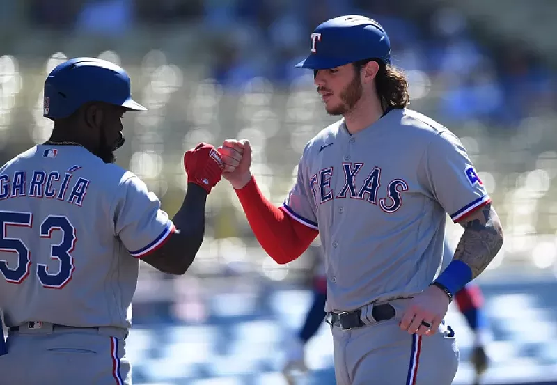 Image: Texas Ranger Jonah Heim celebrates with Adolis Garcia, No. 53, on June 13 in Los Angeles.