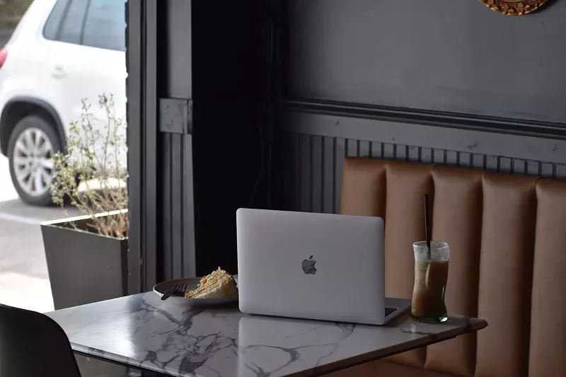 Image: A laptop and cake on a table at B-Side Coffee.