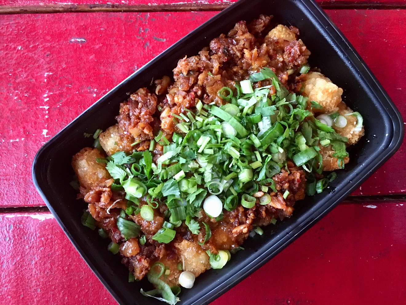 Tater tots topped with Monkey King's chopped peanuts and flash-fried garlic sauce, cilantro and green onions for $8.