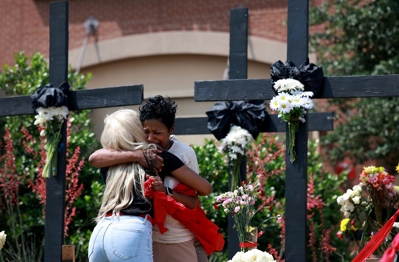 Mourners at a memorial near the scene of the mass shooting at the Allen Premium Outlets mall.