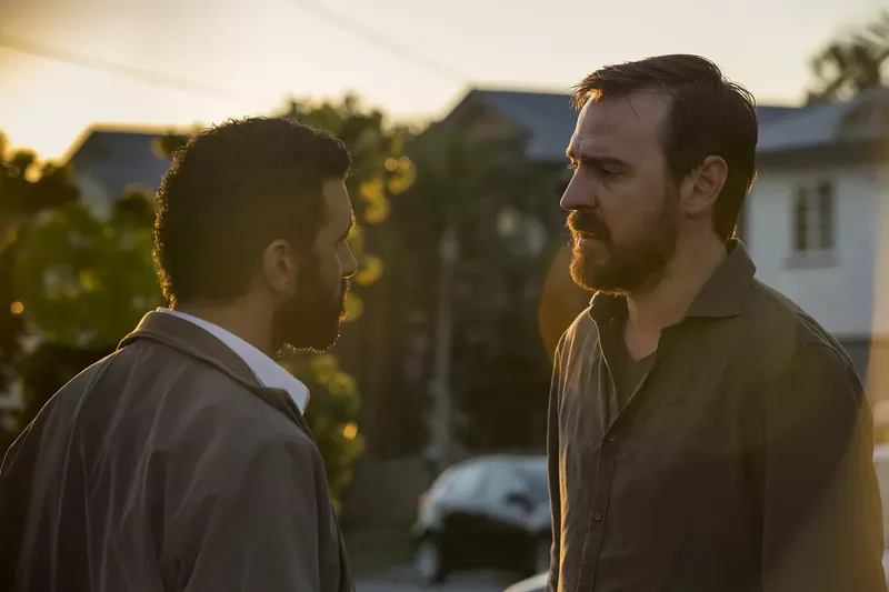 Image: Hazem Shammas (left) plays Ismail, a survivor among 40 refugees found dead in the water, and Ewen Leslie is Ryan, the sailboat’s captain he sees five years later on the streets of Brisbane, in Safe Harbour, a melodrama airing on Hulu.