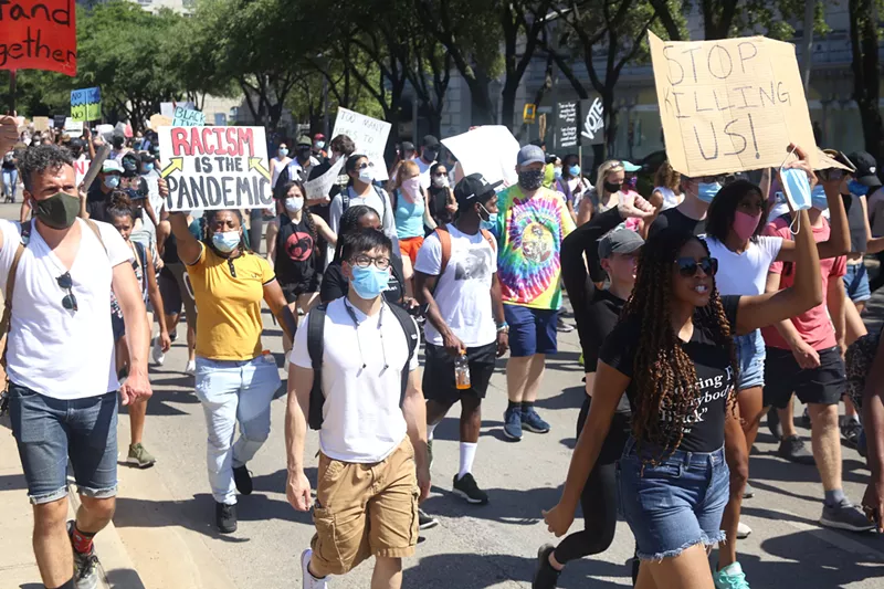 Image: Protesters March in Dallas for the 16th day in a row following an event in Reverchon Park organized by Next Generation Action Network.