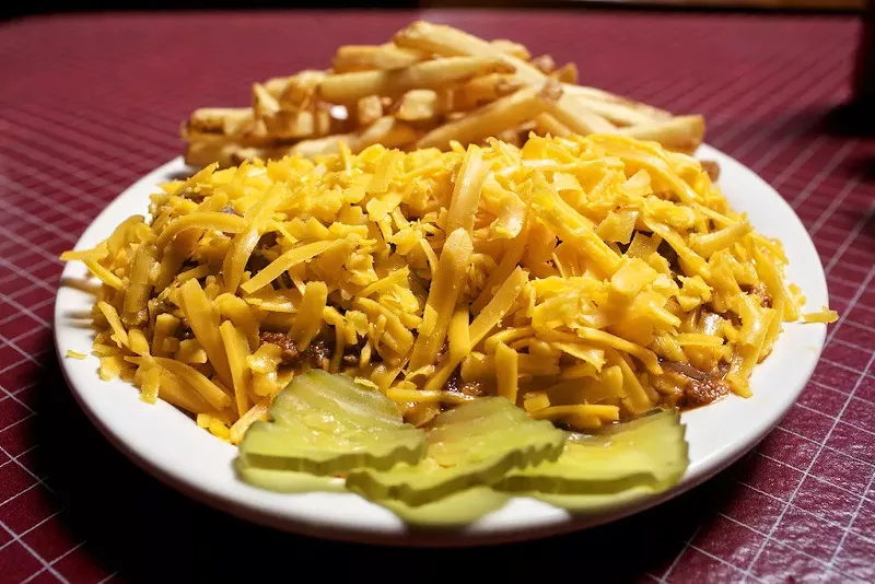 Image: The Angry Dog comes piled high with chili and cheddar.