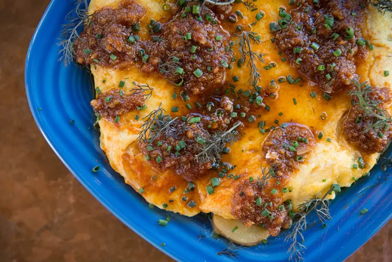 Image: One item staying on the menu: the tortilla española, a tapas classic where eggs and potatoes are folded into a soft, savory layer cake and topped with Izkina’s housemade mojo picon, a Spanish hot sauce made from dried peppers, cumin and garlic.