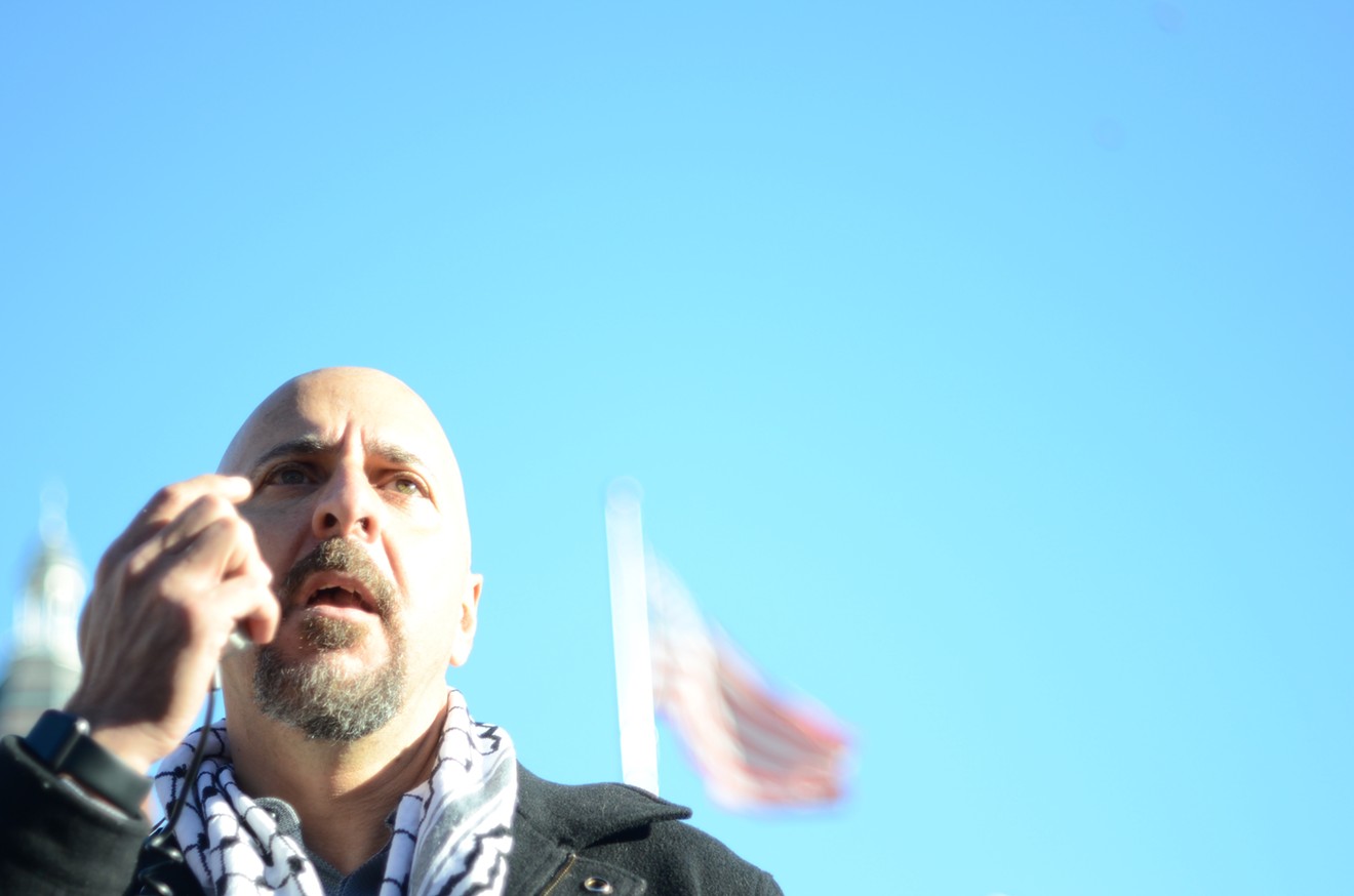 Masoud Khayyat, a coordinator for Dallas Palestine Coalition, chants, "Free, free Palestine!" with the crowd at the Rally for Jerusalem, Capital of Palestine in Dealey Plaza.