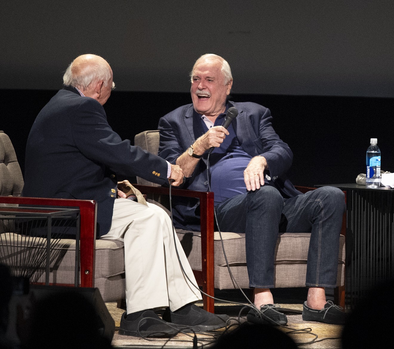 Former KERA program director Ron Devillier, who was the first to air Monty Python's Flying Circus on American televisions in 1975, joins John Cleese onstage at the Texas Theatre on Wednesday. Cleese was in town to receive the Ernie Kovacs Award from the Dallas VideoFest.