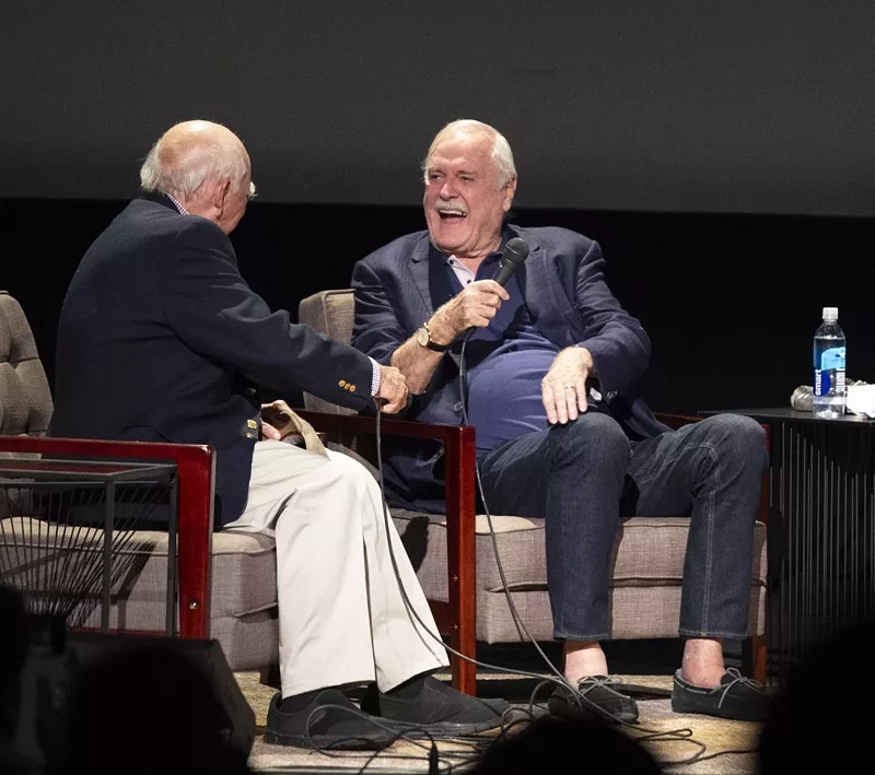 Image: Former KERA program director Ron Devillier, who was the first to air Monty Python's Flying Circus on American televisions in 1975, joins John Cleese onstage at the Texas Theatre on Wednesday. Cleese was in town to receive the Ernie Kovacs Award from the Dallas VideoFest.