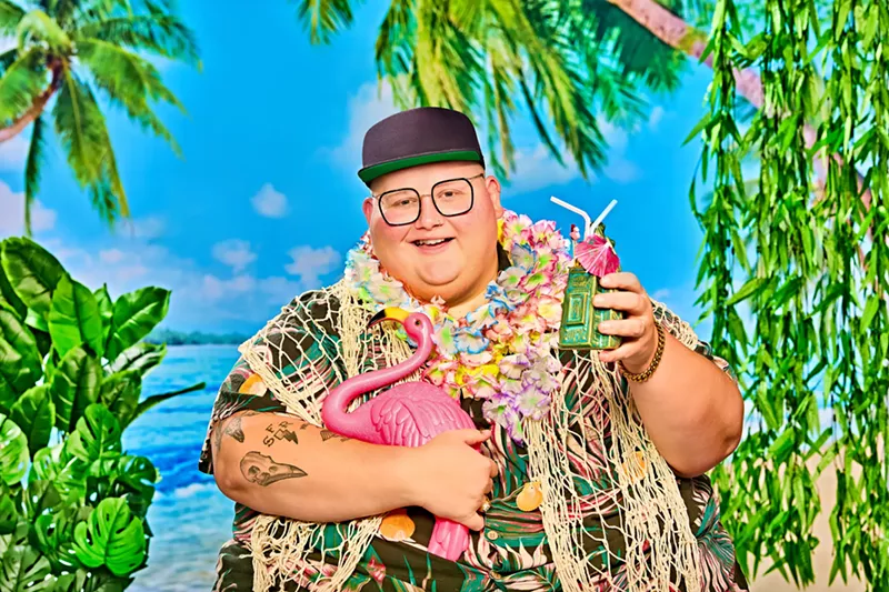 Image: Man holding a drink and flamingo