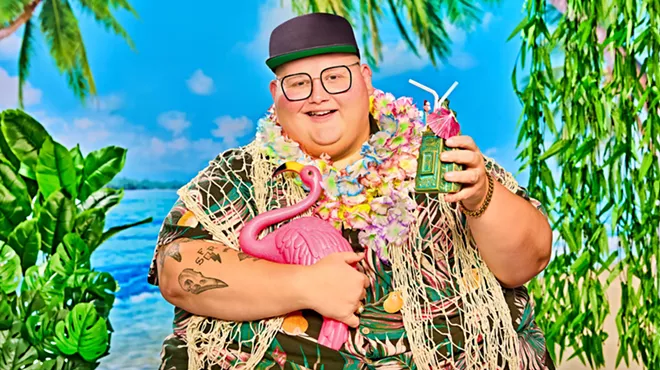 Man holding a drink and flamingo