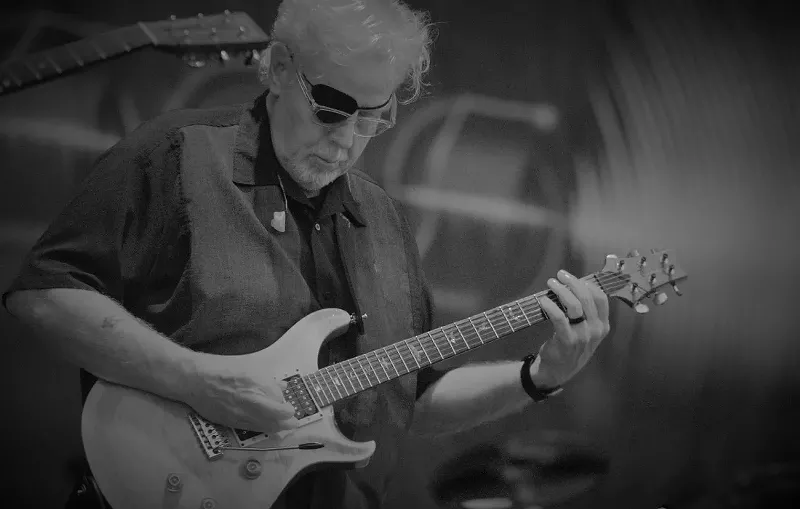 Image: Man playing a guitar