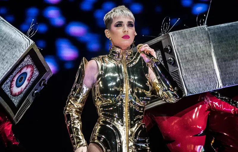 Image: One of Katy Perry's best costumes was a structured, high-neck, gold bodysuit with gold, armor-plated arm pieces.