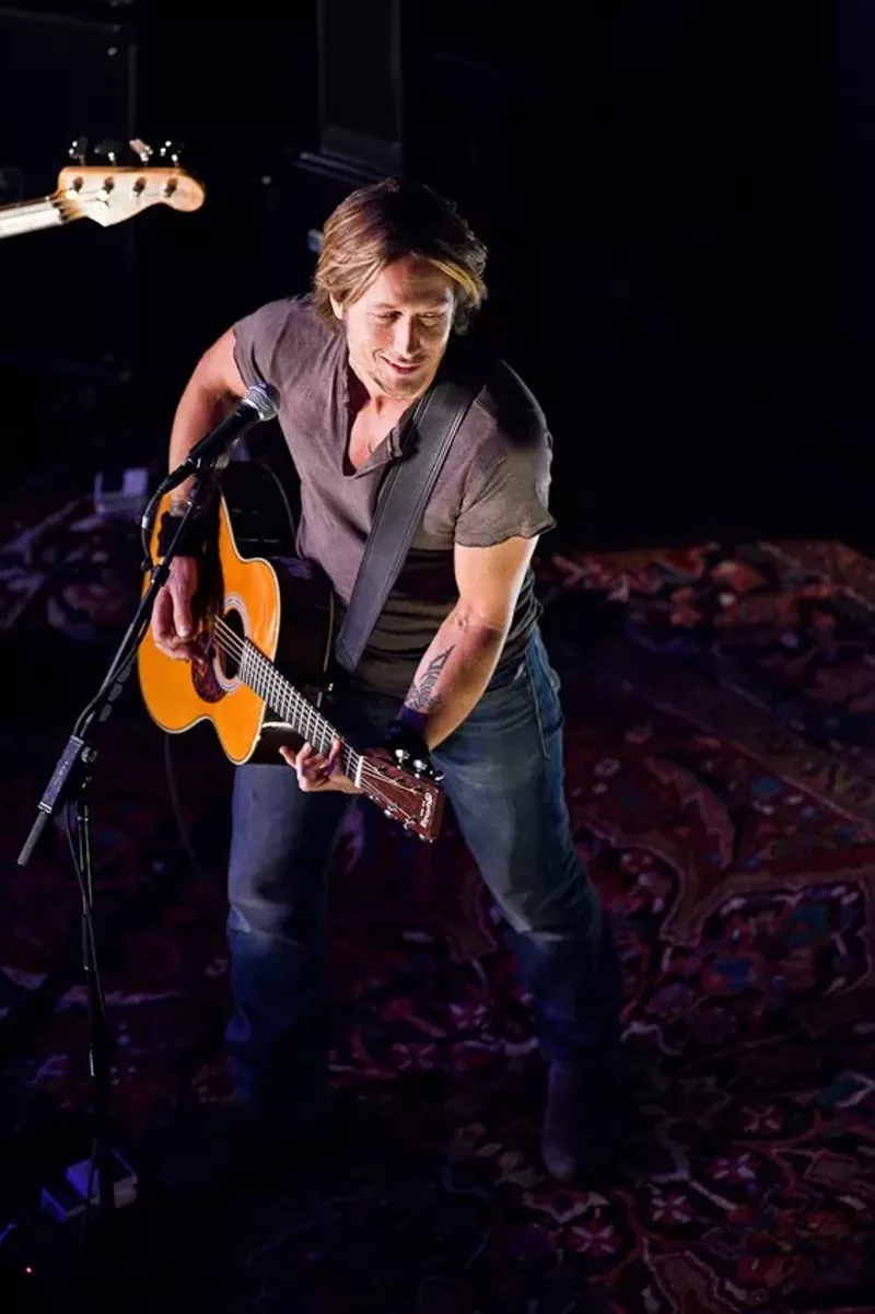 Image: Keith Urban and his guitar onstage in Dallas.