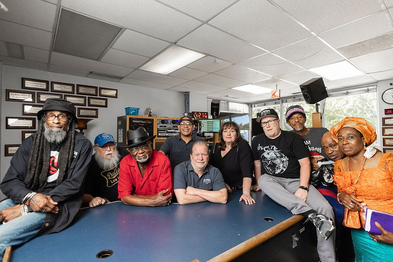 KNON staff and radio personalities, from left: DJ EZ Eddie D, Charlie Don’t Park, Greg A. Smith, DJ Kane, general manager Dave Chaos (center), Blue Lisa, music director Christian Lee, Red Ghost, Ima Uwagbai and Helen Abara.