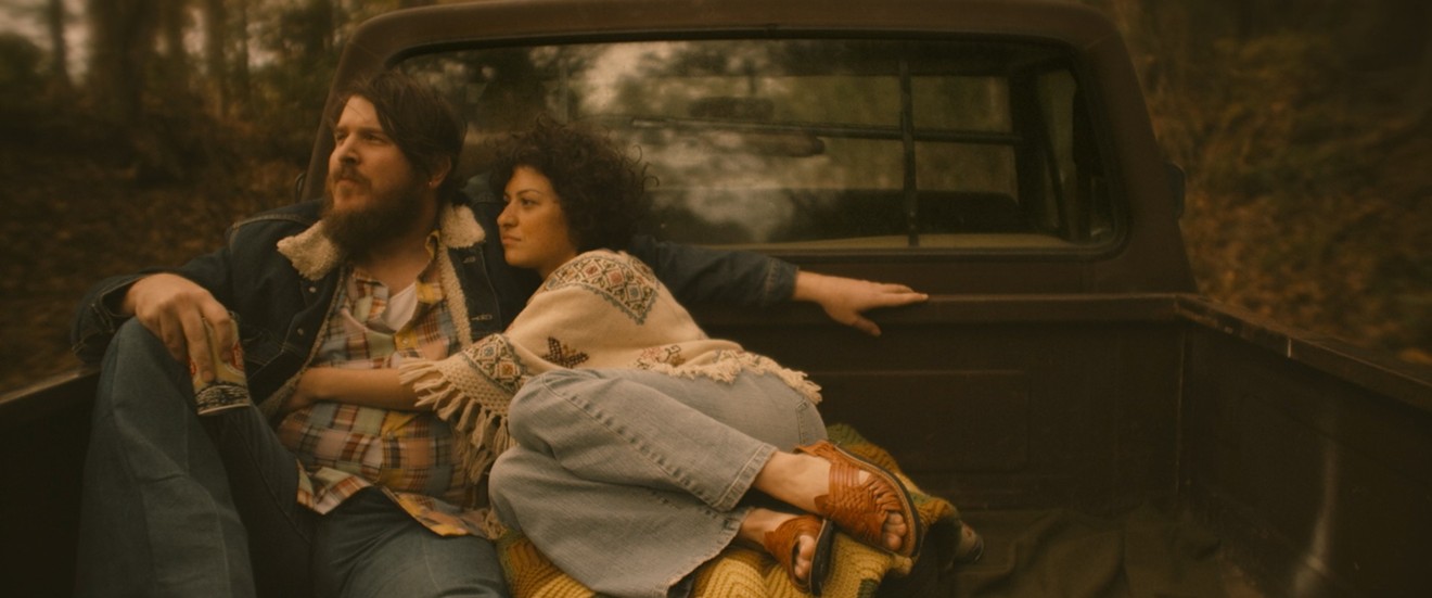 Ben Dickey (left) plays late Texas singer-songwriter Blaze Foley, who lives in an off-the-grid cabin with actress and writer Sybil Rosen (Alia Shawkat), in Blaze, Ethan Hawke’s impassioned and uncompromising study of musicians on the margins.